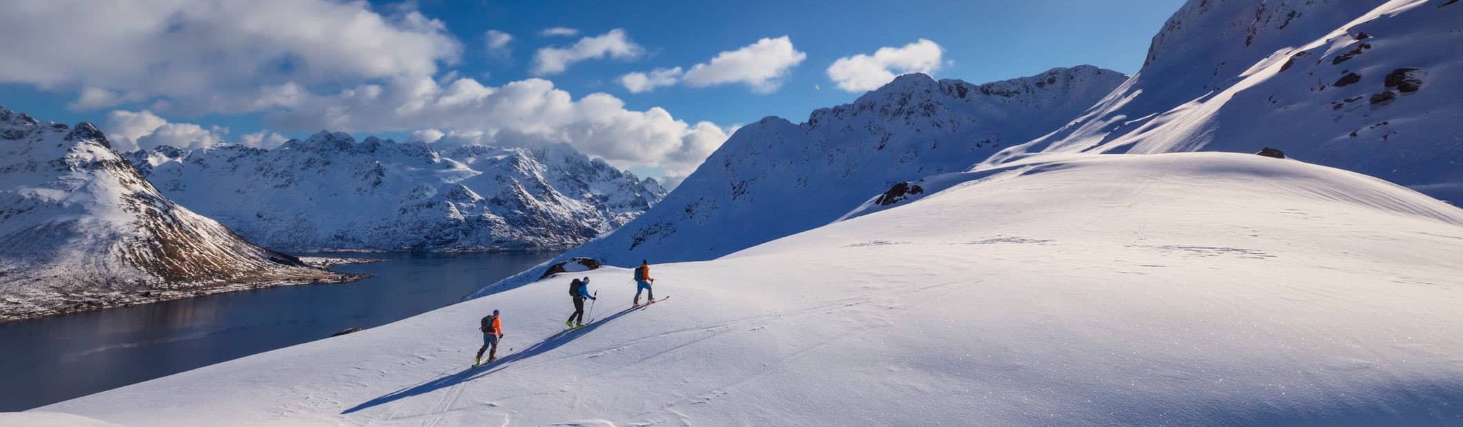 skiers going across mountain