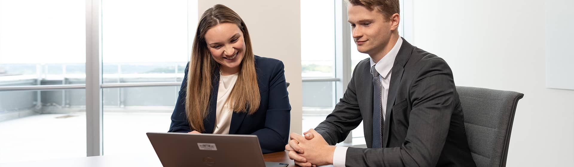 Two associates reviewing computer together