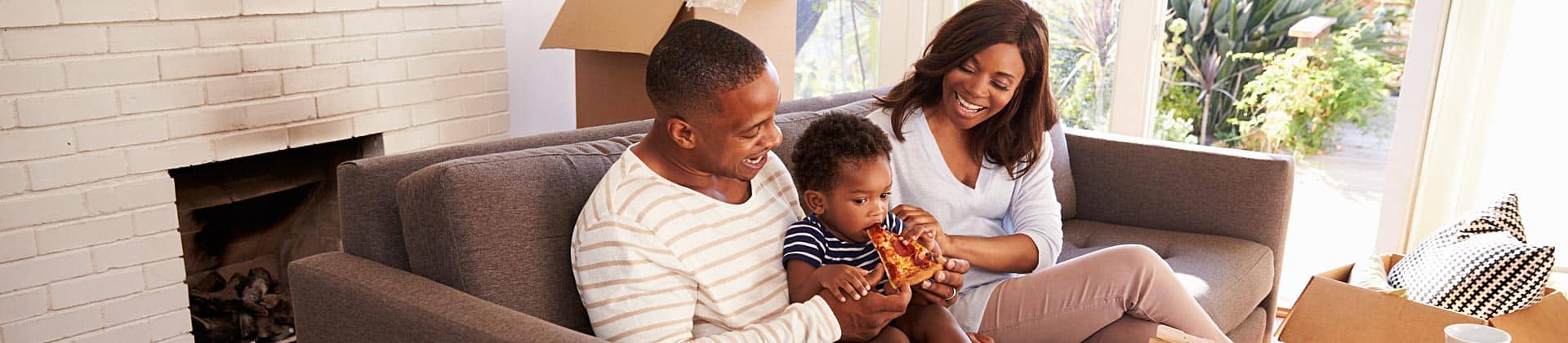 Family enjoying pizze after moving into a new home