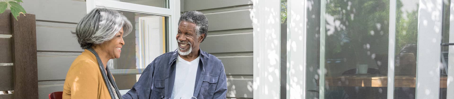 elder couple conversing on the porch