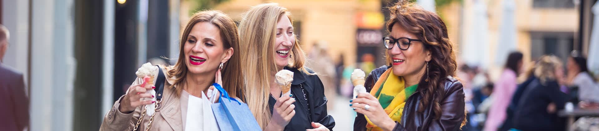 3 women enjoying ice cream on the street