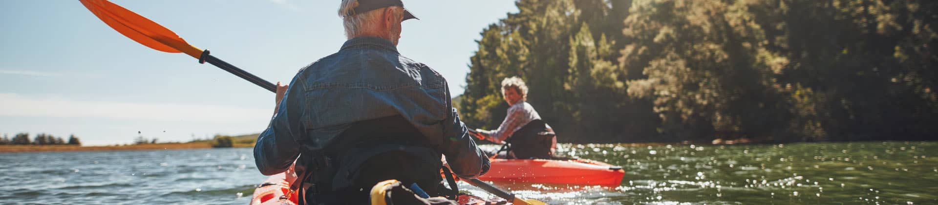 Retired couple kayaking down the river