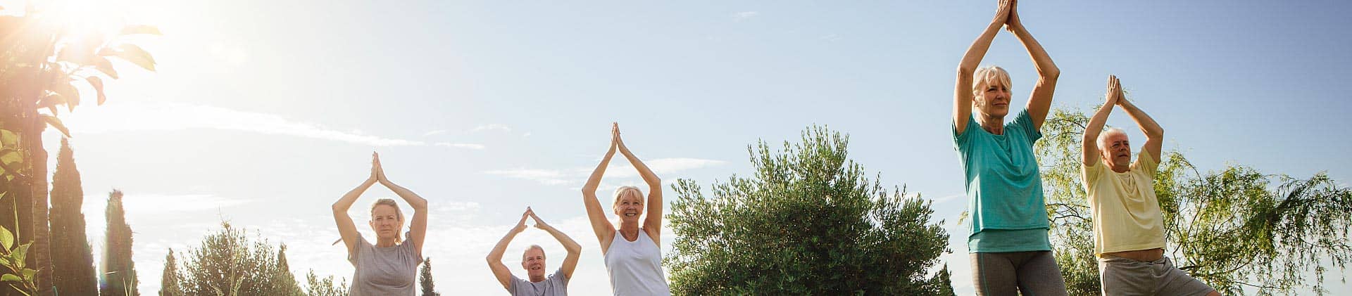 Senior yoga class outdoors 
