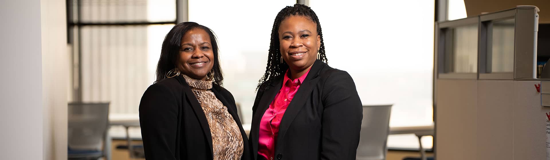 Two associates smiling together at work