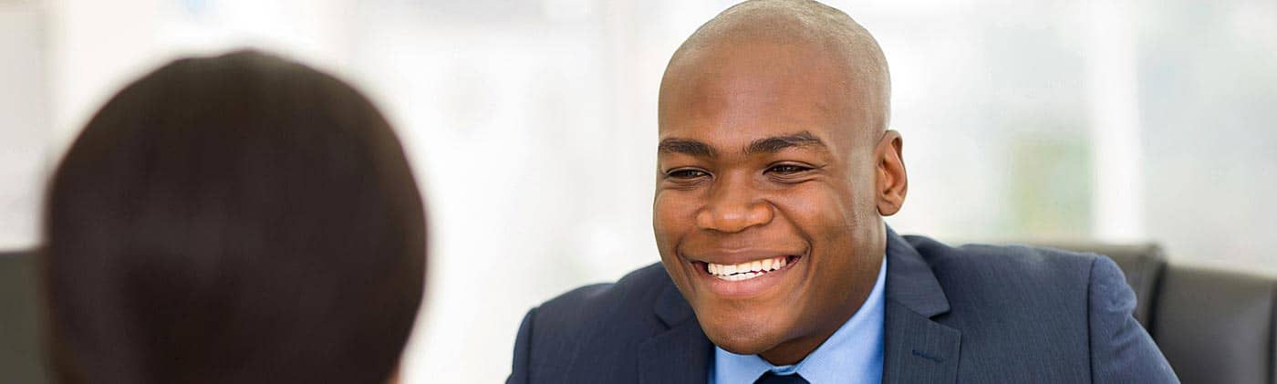 A business person conducting a job interview with a candidate: when should you get life insurance