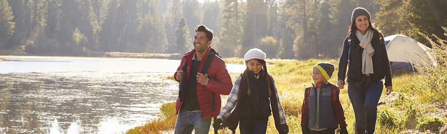 A family on a walk in nature discussing what life insurance is 
