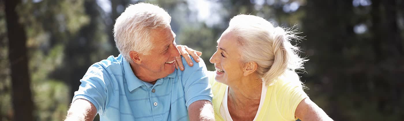 A happy couple embrace and smile after purchasing a single premium annuity 
