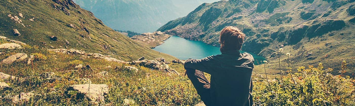 A man goes for a hike in a beautiful valley: personal insurance plans