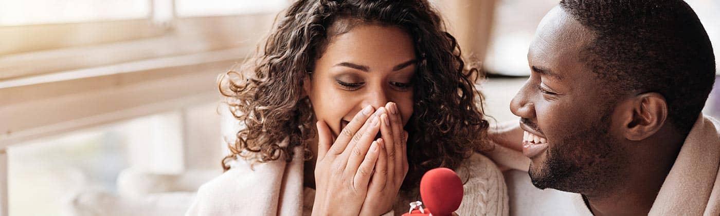 man surprises woman with engagement ring and plans financial conversations to have before marriage