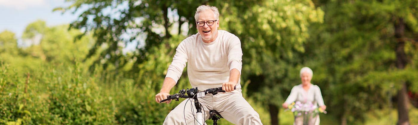 mature couple rides bikes and decides whether a roth individual retirement account is right for them