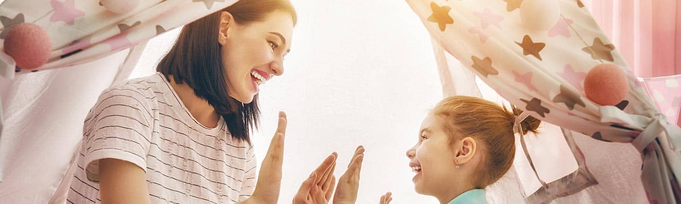 A mother plays a game with her young daughter: term life insurance
