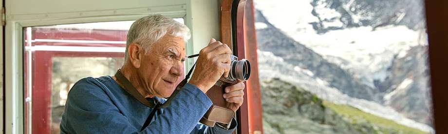 A older man honing his photography skills which is one retirement hobby that makes money 