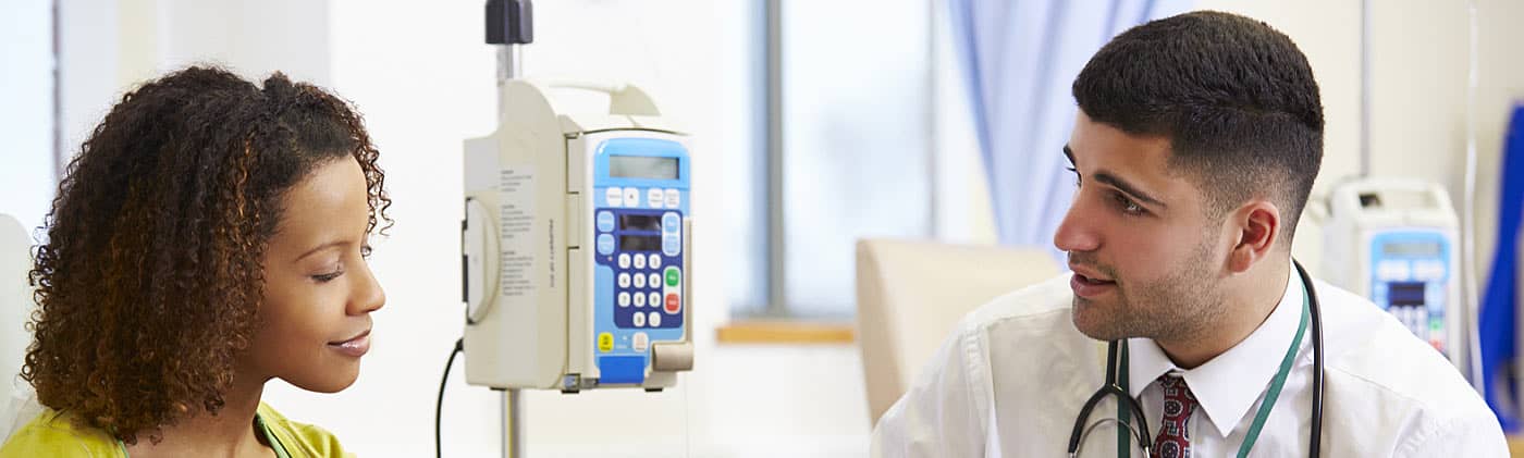 A patient discussing the difference between critical illness and health insurance with her doctor 