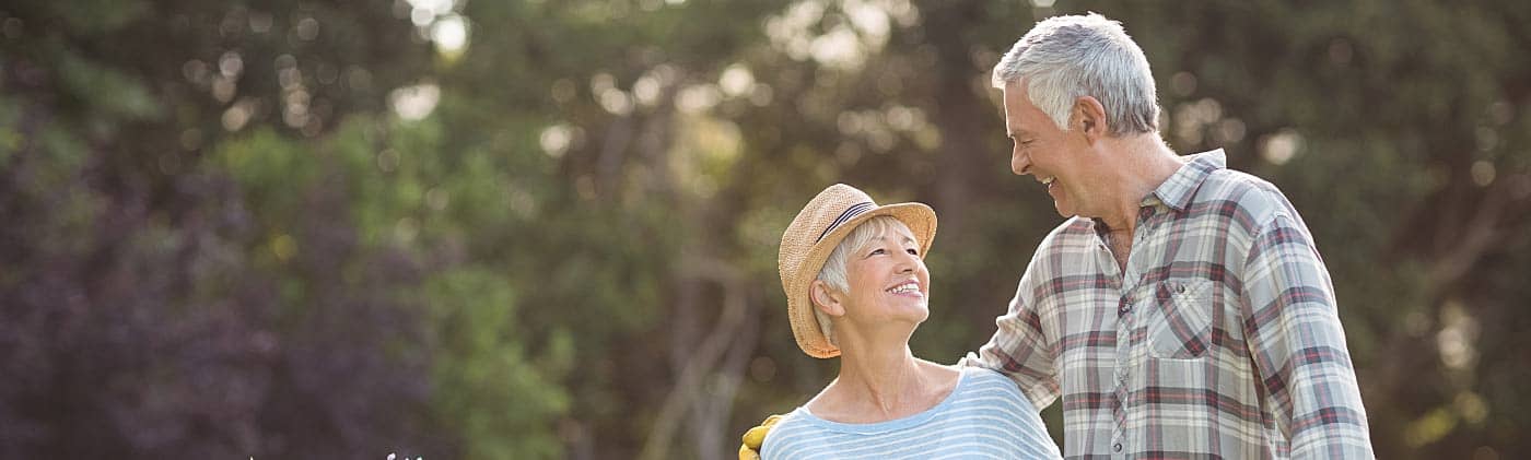 A senior couple hugging in the garden after discussing life insurance for seniors