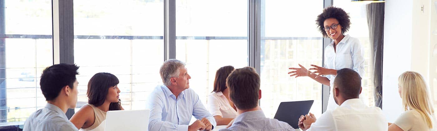 a small-business owner has a meeting with her staff in a modern office financial priorities