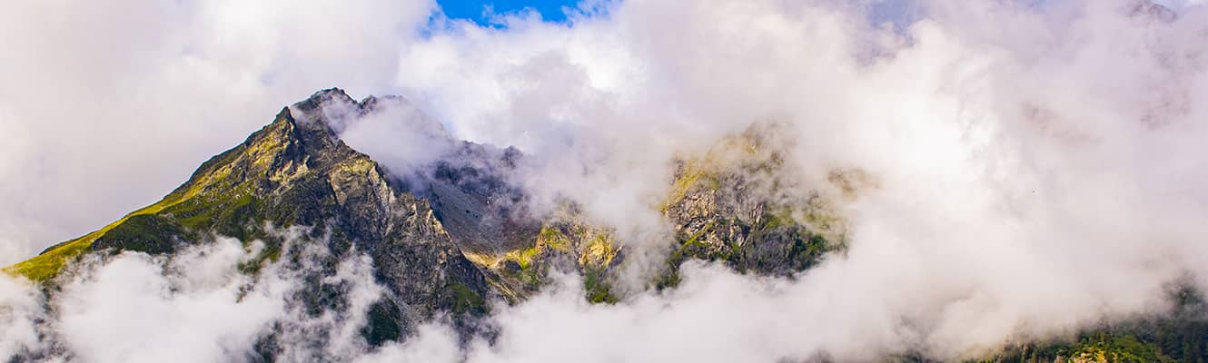 clouds lifting over mountain