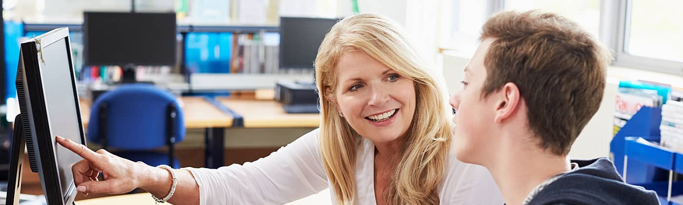 male student meets with career advisor to discuss trade school, vocational school and online degrees