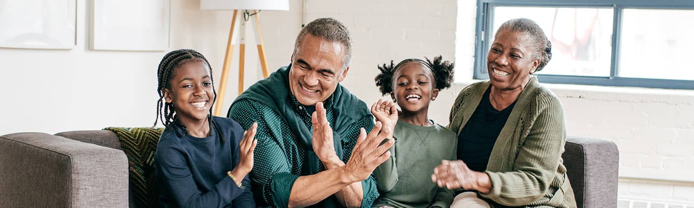 Grandparents enjoying time on the couch with the granddaughters
