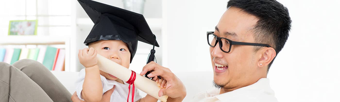 Dad with baby in graduation cap