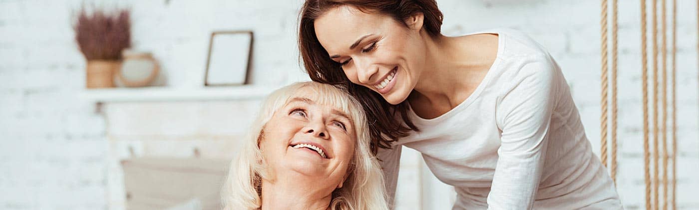 daughter cares for her mom in a wheelchair at home and wonders about ways of coping as a caregiver