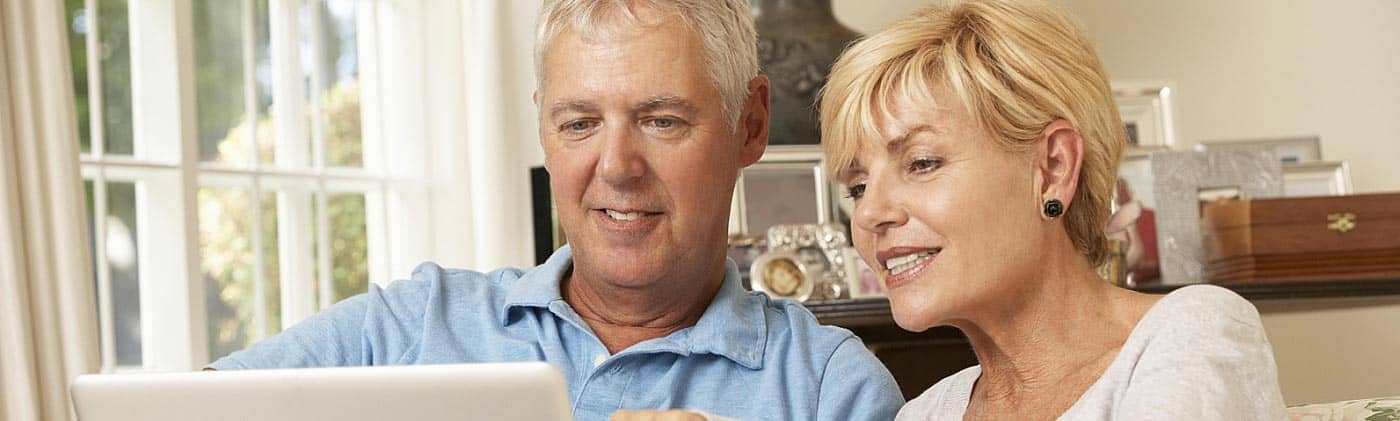 Couple going over retirement plan together at home: transition to retirement