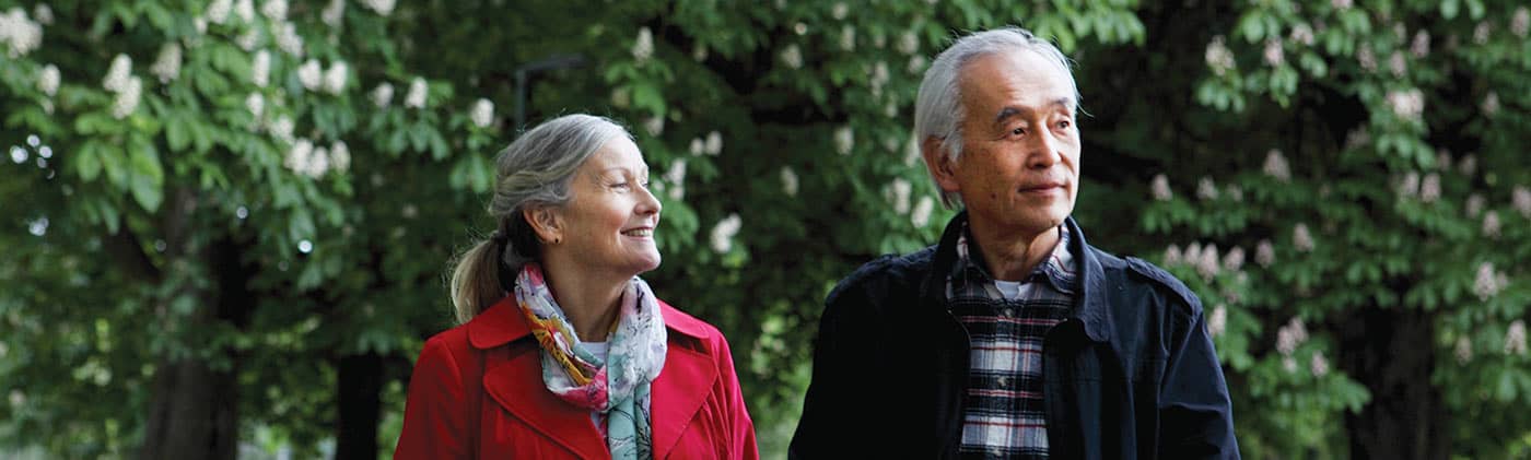 Couple walking through park empty nester consider shaking up your financial plan