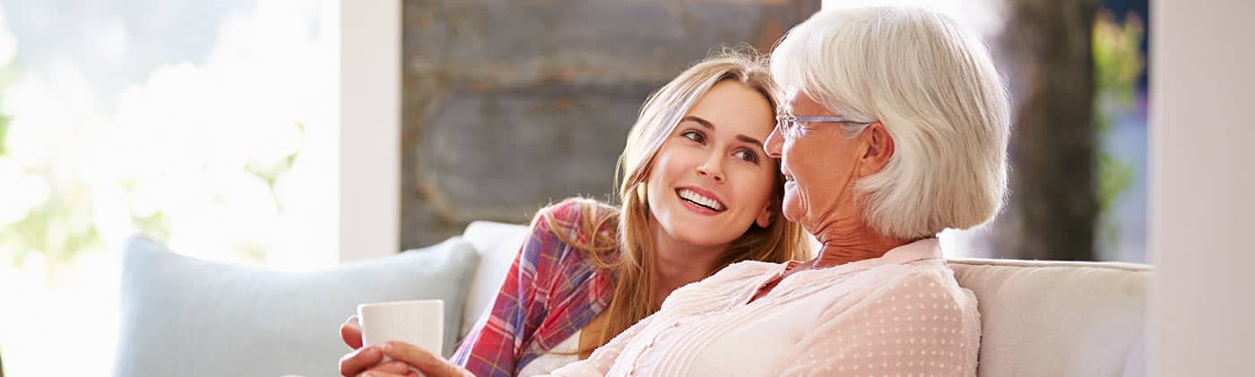 daughter and older mother drinking coffee after researching a will