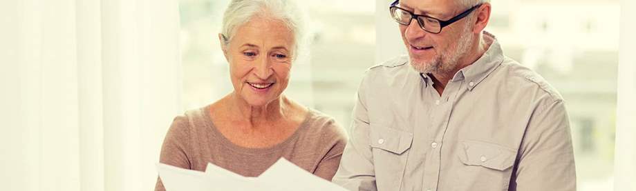 An older couple reviews a document about their full retirement age and Social Security benefits. 