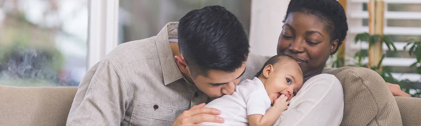 Family with newborn baby budgeting for a baby