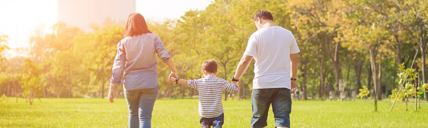 Family of three walks and discusses why life insurance is an important part of their future planning 