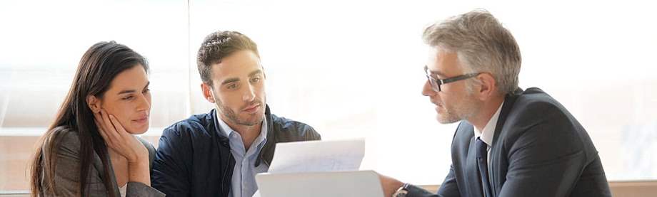 financial advisor explains the impact of inflation on savings and investments to a young couple