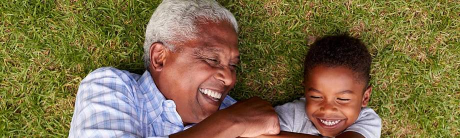 Grandfather laughing with grandson after discussing a modified endowment contract 