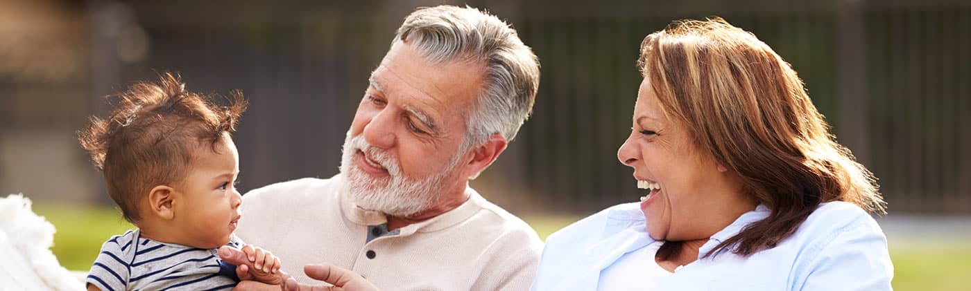 Grandparents with grandbaby laughing not saving for retirement heres the cost of waiting