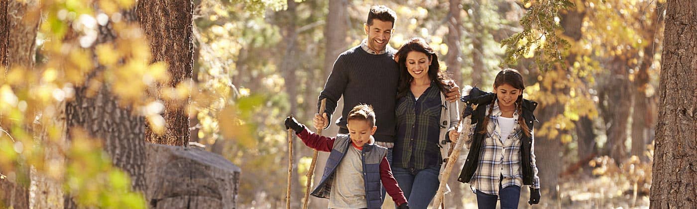 happy family walking in the forest 10 year term life insurance
