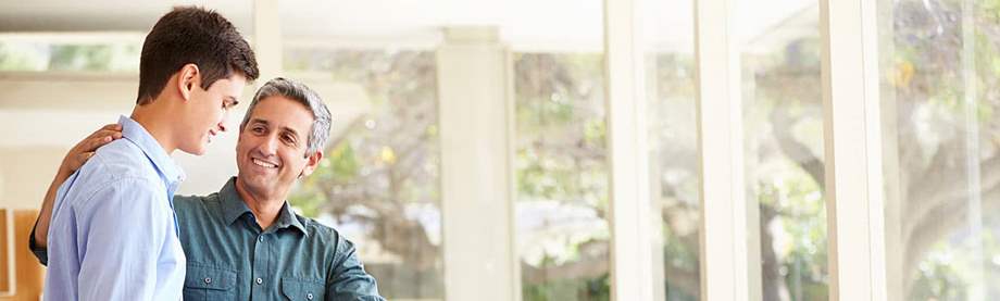 Happy father sending his son to college thanks to attainable college funding options