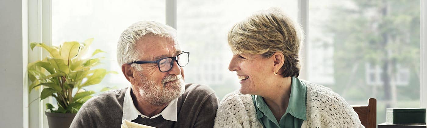 senior couple eats at home and decides to discuss when to start saving for retirement with their kids
