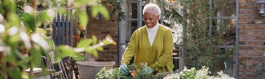 happy older woman gardening after researching power of attorney