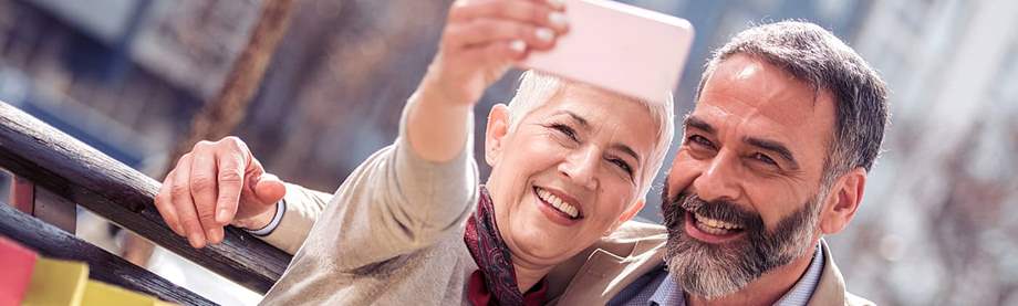 happy senior couple takes a selfie and imagines retiring together due to solid retirement planning