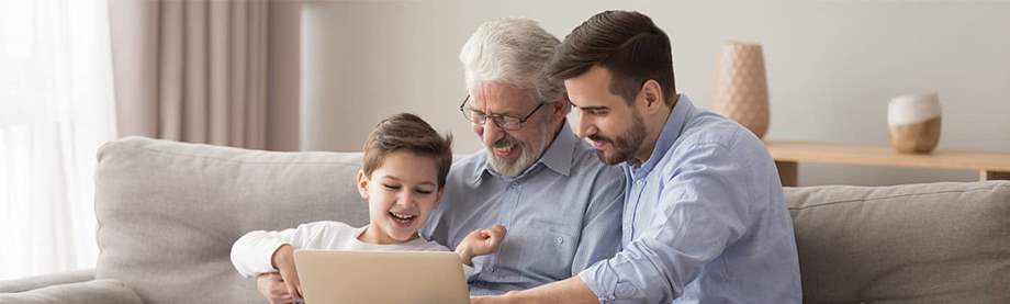 Happy three age multigenerational men looking at the computer.