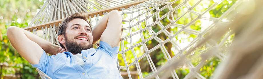 Young man in a hammock asks himself, "How much money do I need to retire at 40?"