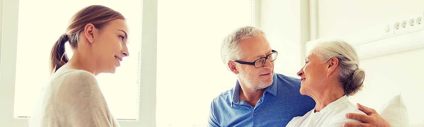 husband and daughter of older woman in hospital all discuss planning a funeral service ahead of time