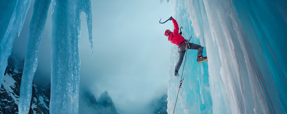 man climbing an ice mountain