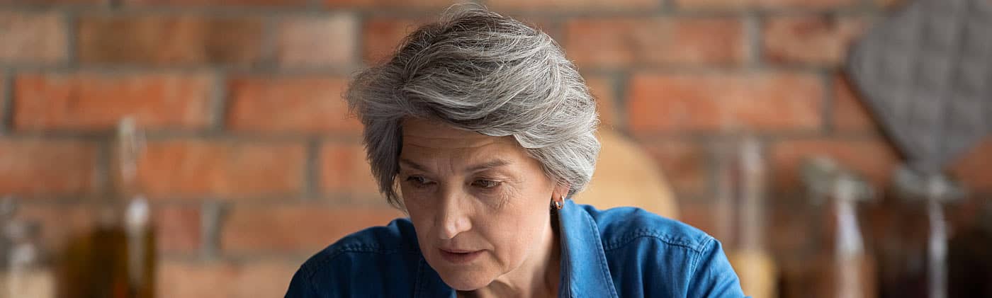 A woman reviews paperwork and researches income replacement insurance