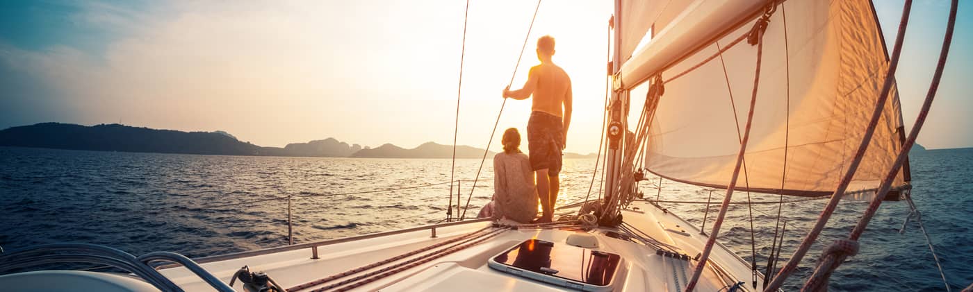 Couple enjoying sunset from the sailboat
