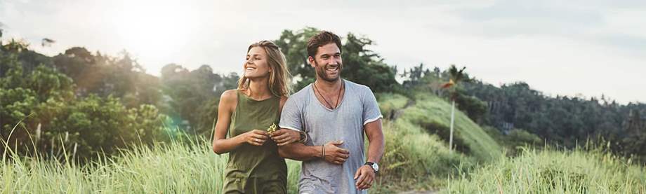 A couple happily walking while they think about their long term savings.