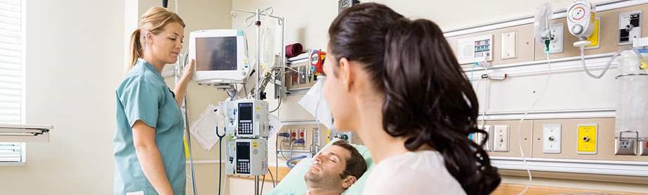 A medical provider talks with a patient's spouse about critical illness riders. 