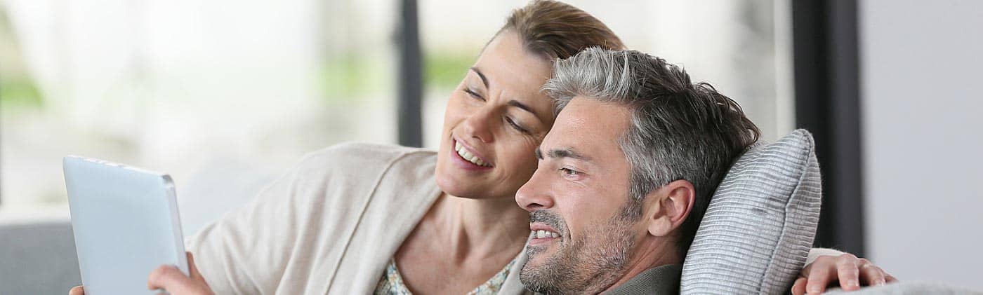 mature couple preparing their budget on a tablet personal budget