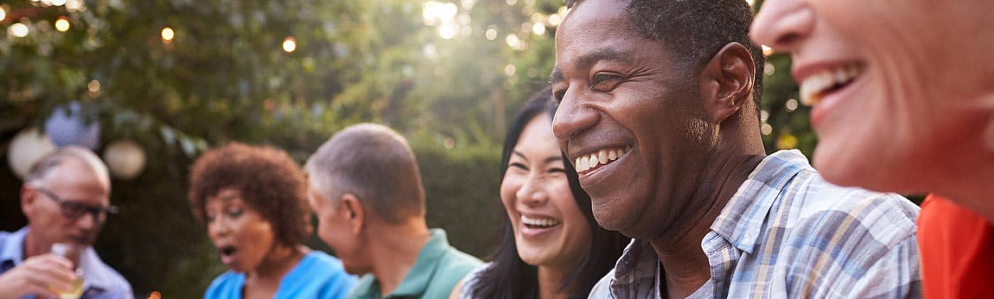 friends celebrate life after retirement at backyard party and discuss how to stretch your savings