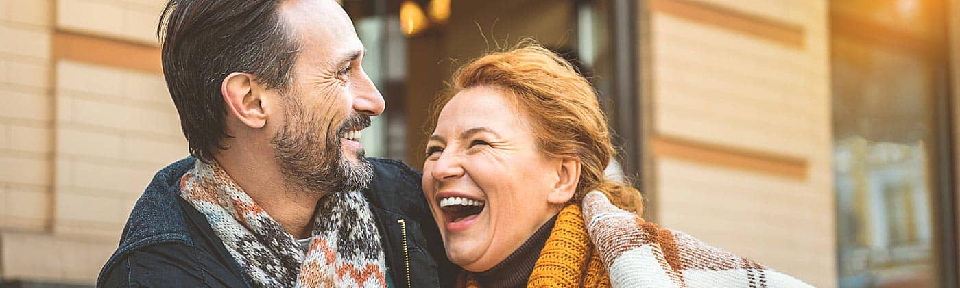 Middle-aged couple laughing in a cafe: planning for retirement