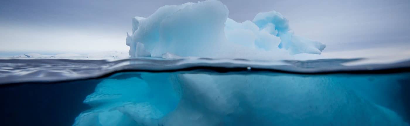 Iceberg under and over water.